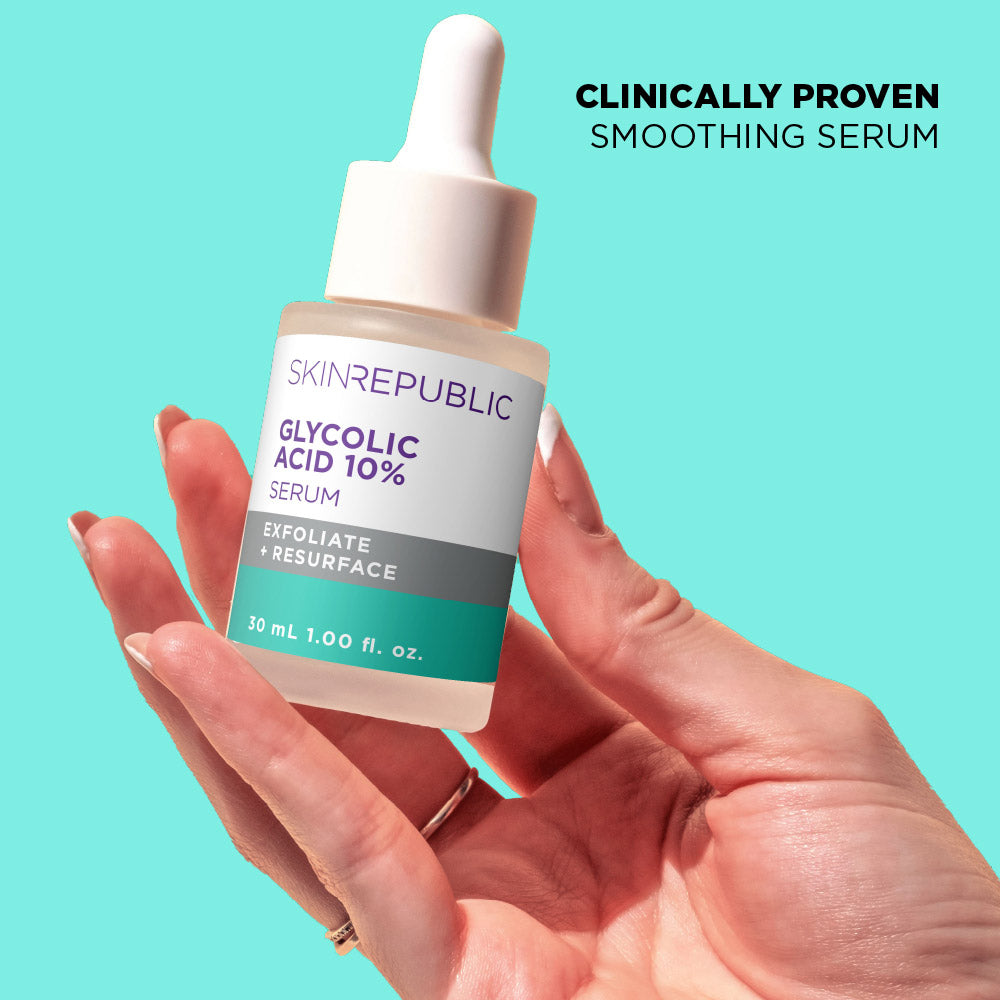 Hand holding a bottle of Skin Republic Glycolic Acid 10% Serum against a teal background
